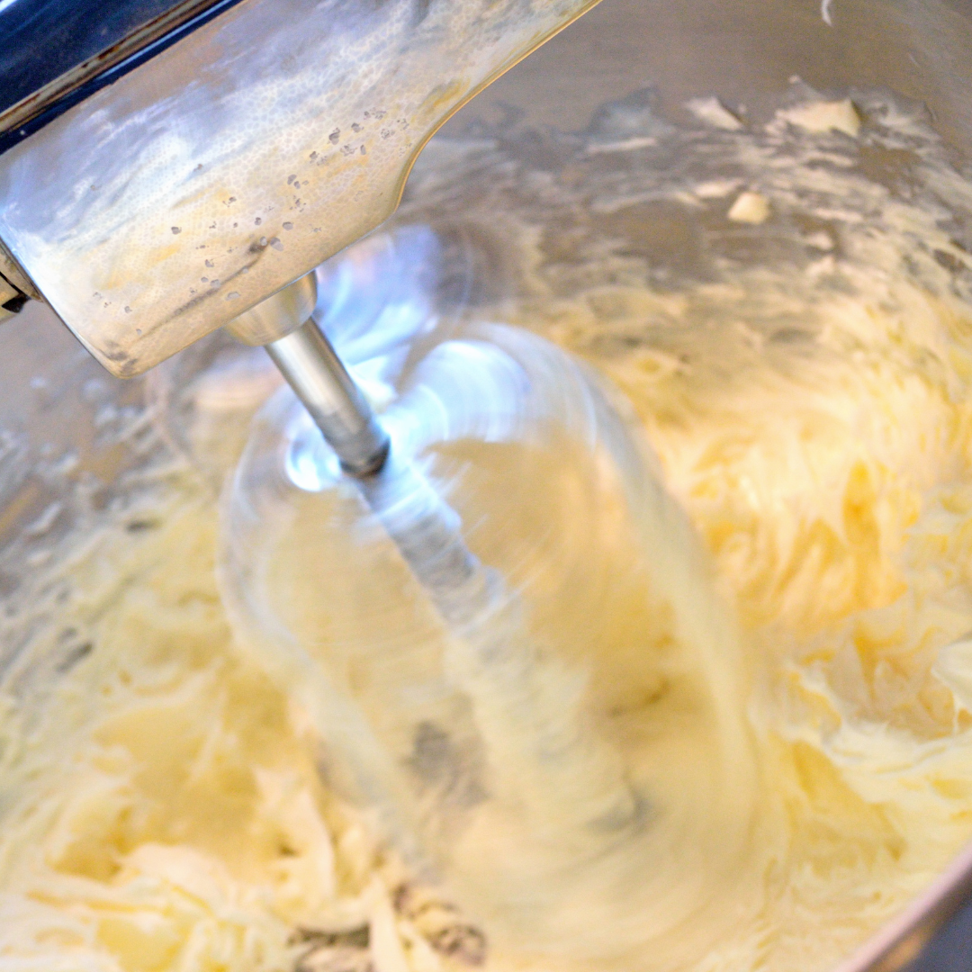 A mixer spinning creaming butter and sugar