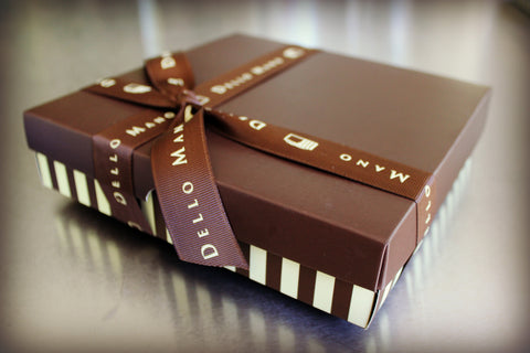 Dello Mano Chocolate Gift box with brown and cream and finished with ribbon that says Dello Mano