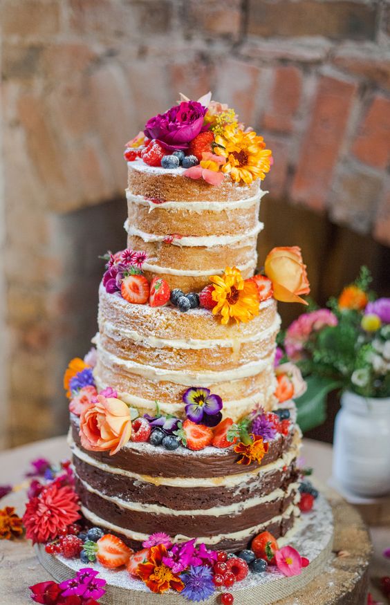 Stunning naked wedding cake with organic edible flowers from http://maddocksfarmorganics.co.uk. Cake made by http://www.theorganicweddingcakecompany.com. Photography by Ria Beth Photography. Wedding of the lovely Abiee and Tom Thank you all!
