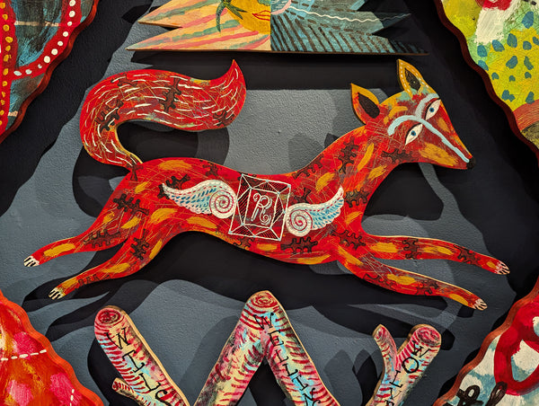 Detail from a work of art by Jonny Hannah of a brightly painted fox