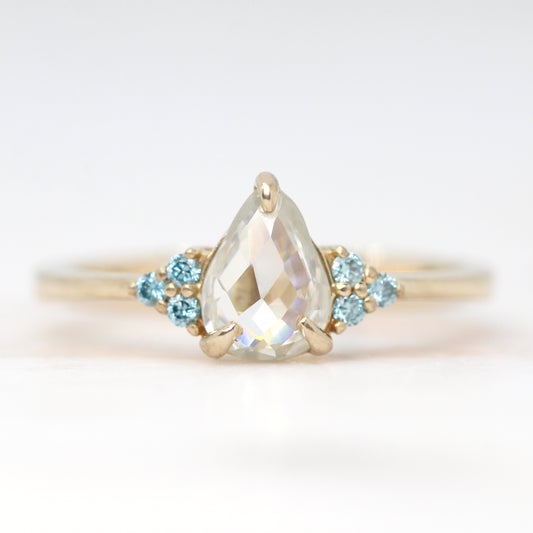 Imogene Ring with a 0.74 Carat Clear Pear Moissanite and Blue Diamond Accents in 14k Yellow Gold - Ready to Size and Ship - Midwinter Co. Alternative Bridal Rings and Modern Fine Jewelry