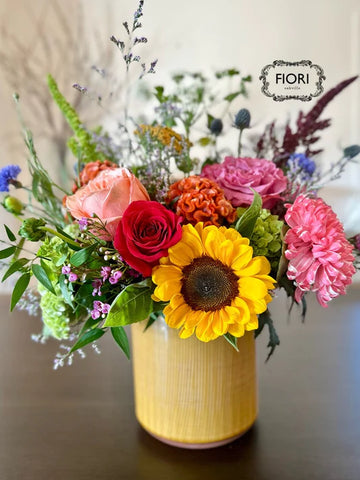 honey pot flower arrangement in light yellow vase