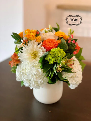 pumpkin spice flower arrangement in white vase