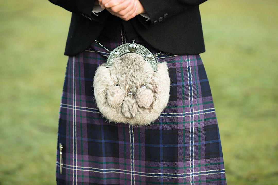 Scottish bagpiper dressed in kilt playing bag pipes, lower part with tartan  skirt Stock Photo by ©Julietart 80652350