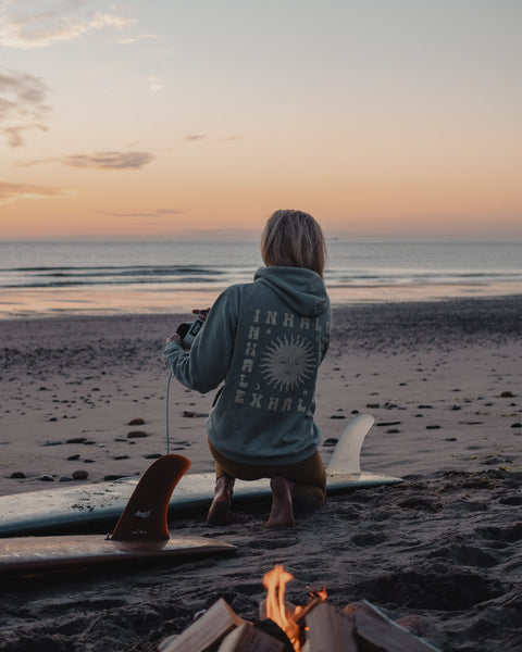 Post Surf Beach Fire wearing our 'Inhale Exhale' Hoody