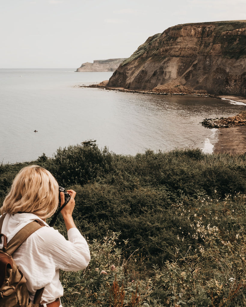 Lucy taking a photo of Port Mulgrave beach