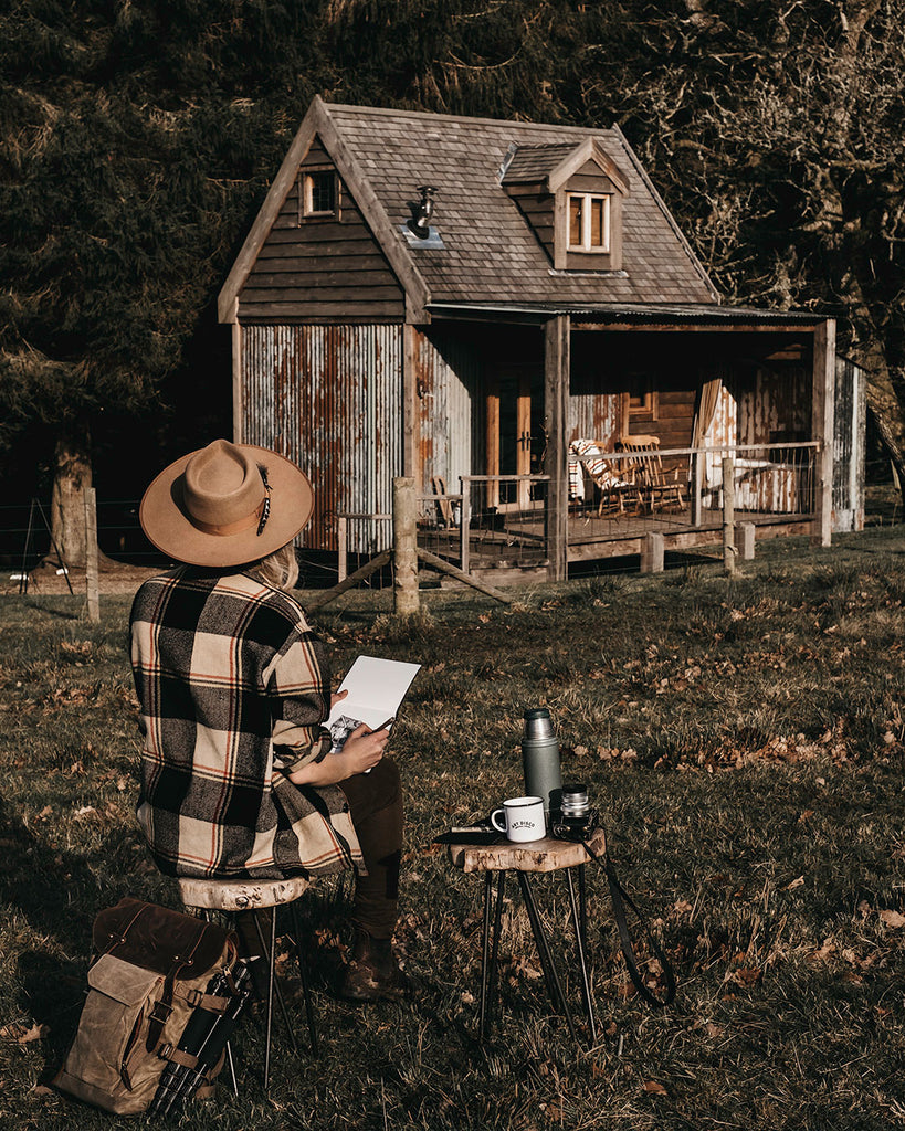 Lucy sat sketching the cabin 