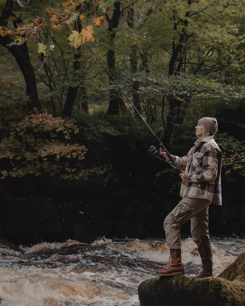 Lucy fishing by the river