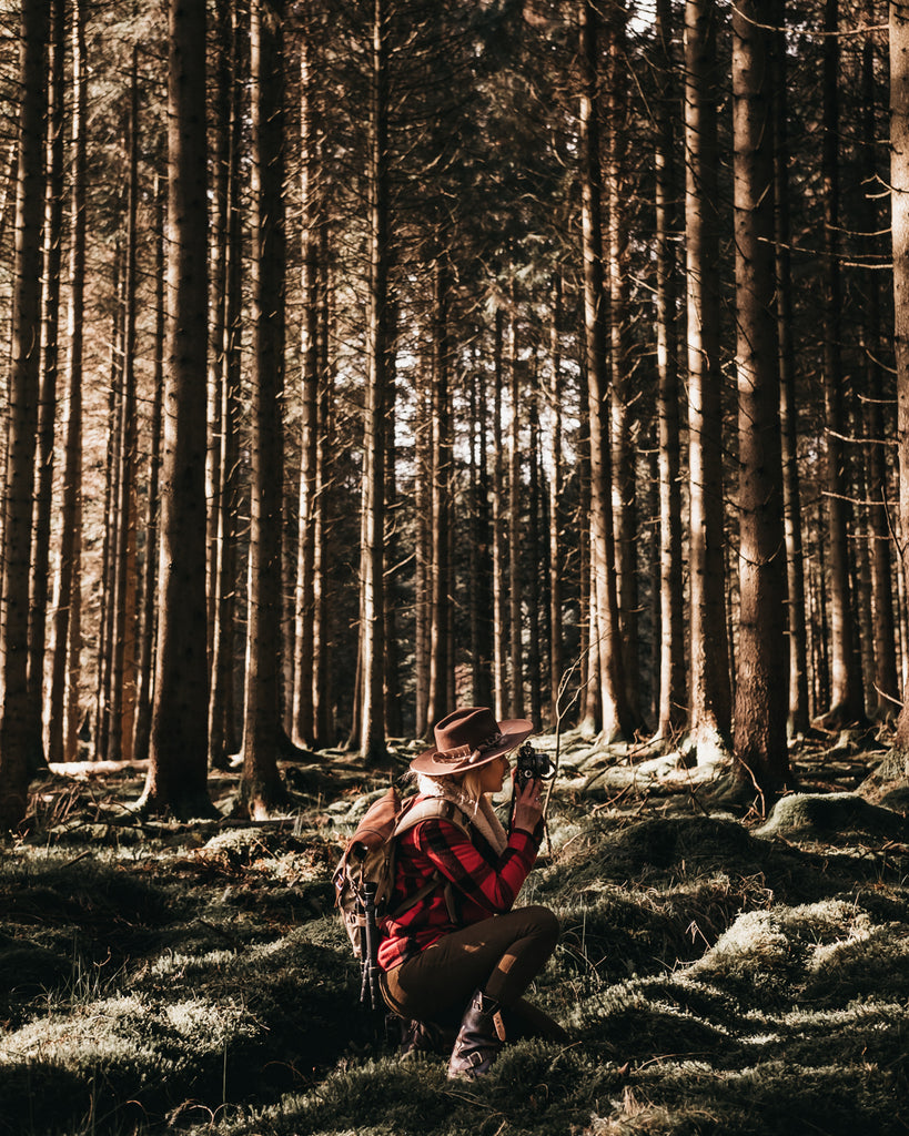 Lucy taking photos in the woods at Kielder Forest