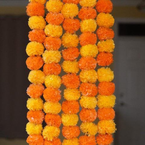 Dark orange and light yellow marigold garlands from aangan of india.  These garlands are perfect for halloween decoration, diwali, and dia de los muertos (day of the dead) decoration
