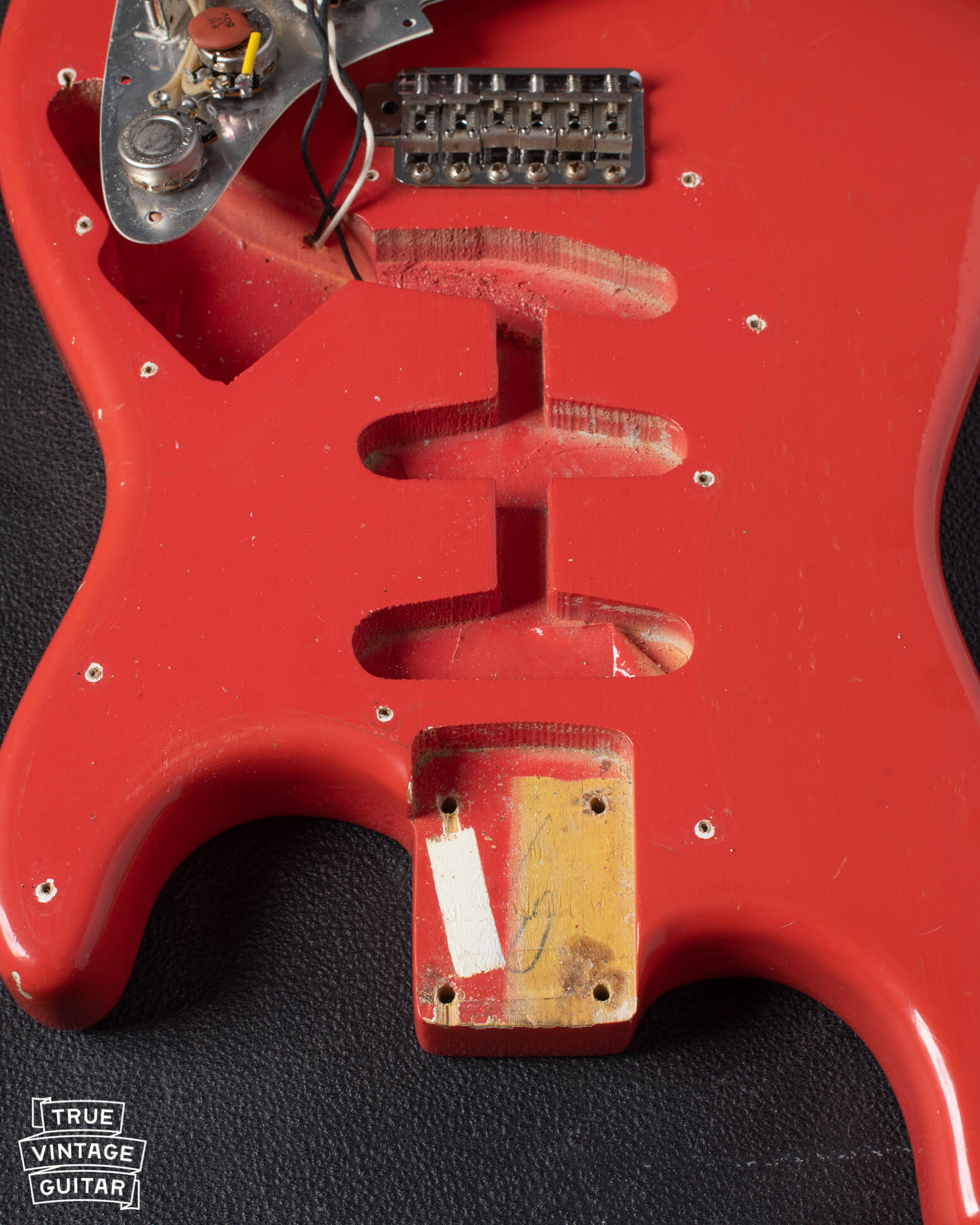 Fiesta Red Stratocaster neck pocket with paint stick, pickup cavities, white undercoat