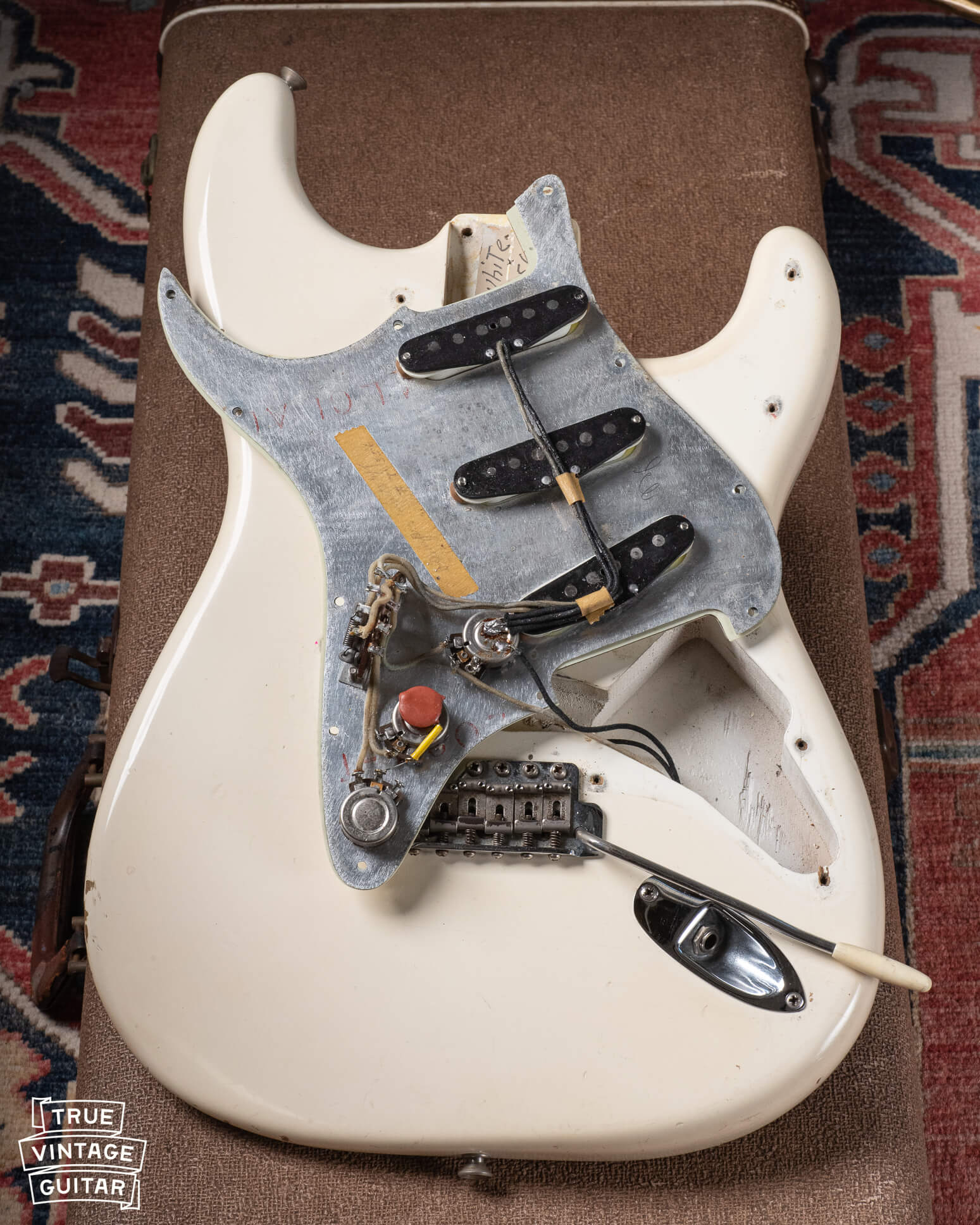 1961 Stratocaster pickguard with pickups, potentiometers, switch, and masking tape