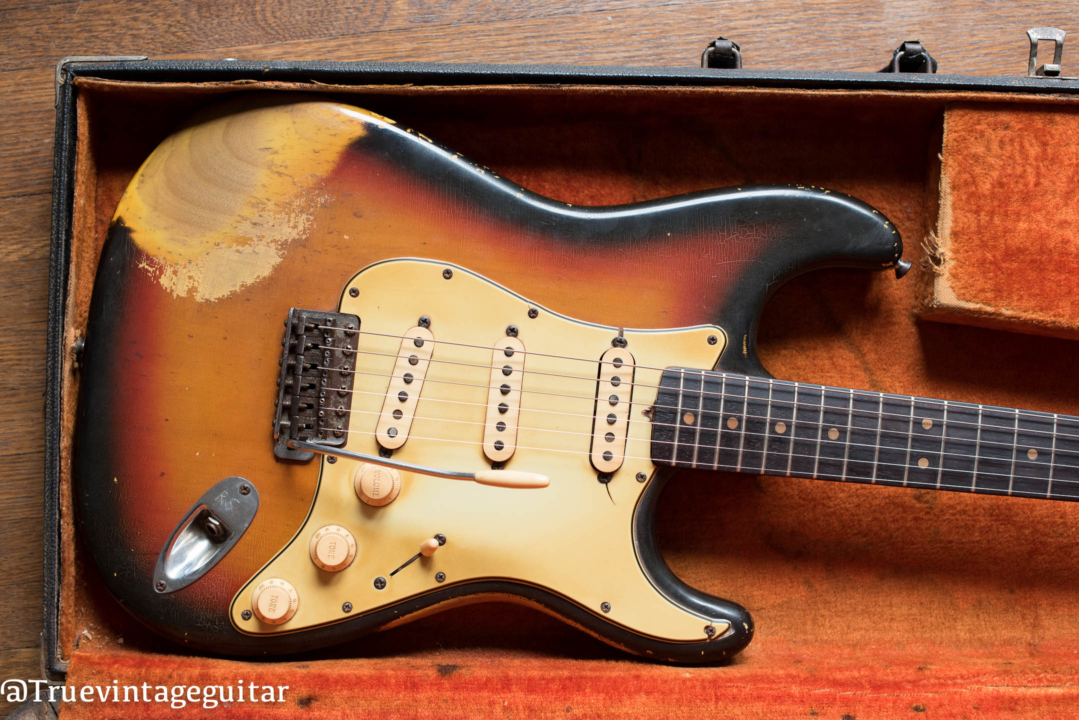 Vintage 1964 Fender Stratocaster with Sunburst finish and mint green pickguard