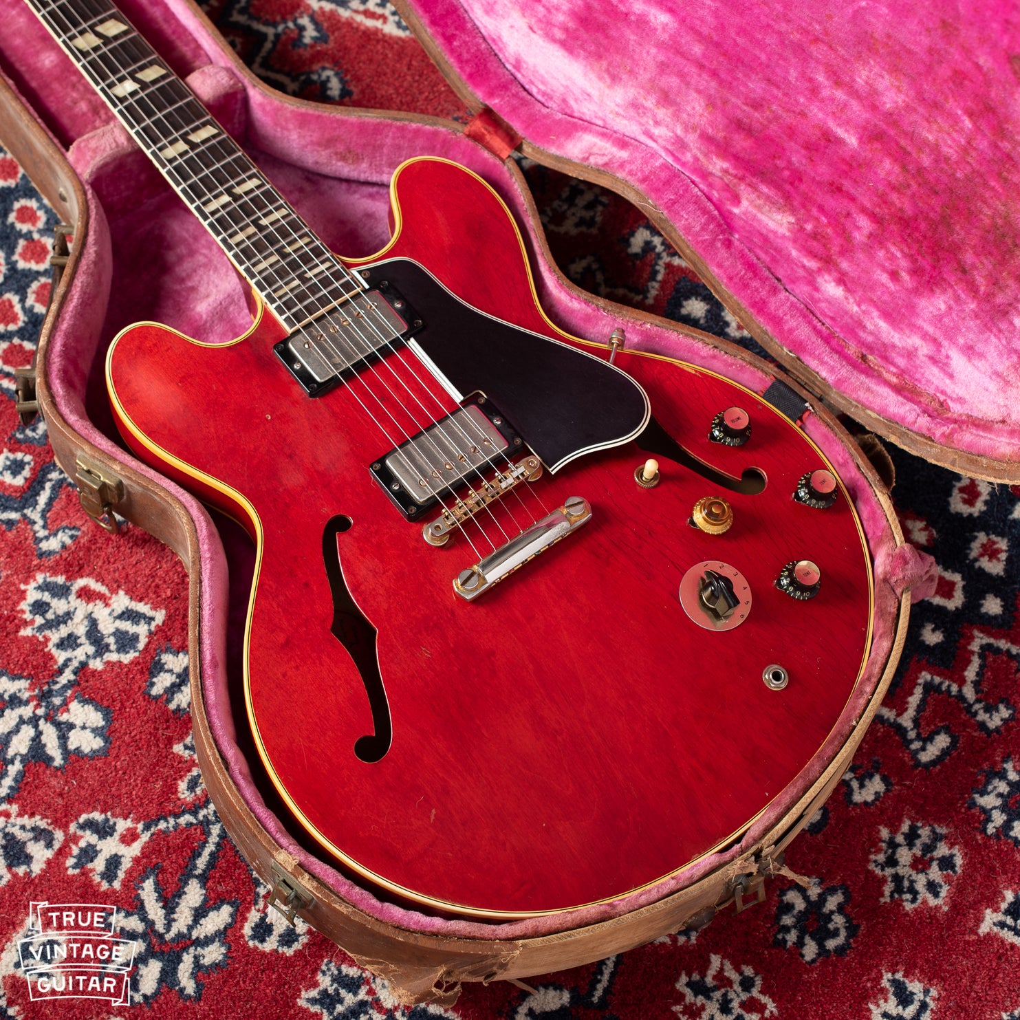 Gibson ES-345 guitar red with stop bar stop tail tailpiece and long pickguard. Pink interior case with brown exterior Lifton.