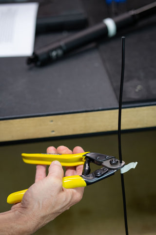 image showing cable housing being cut with cable cutter