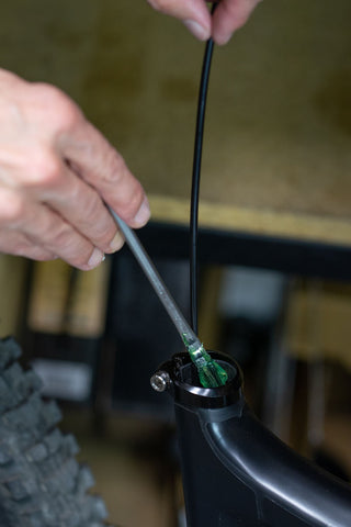 image showing a brush applying grease inside of the top tube