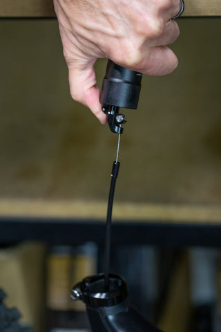 image showing a thumb pulling on the actuator arm