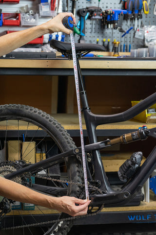 image showing seatpost installed in frame with tape measure to set desired height