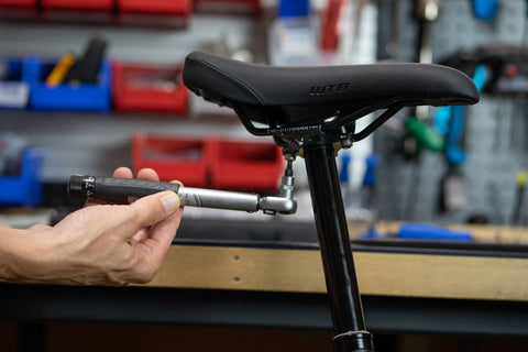 image showing torque wrench being used to tighten rear saddle clamp bolt