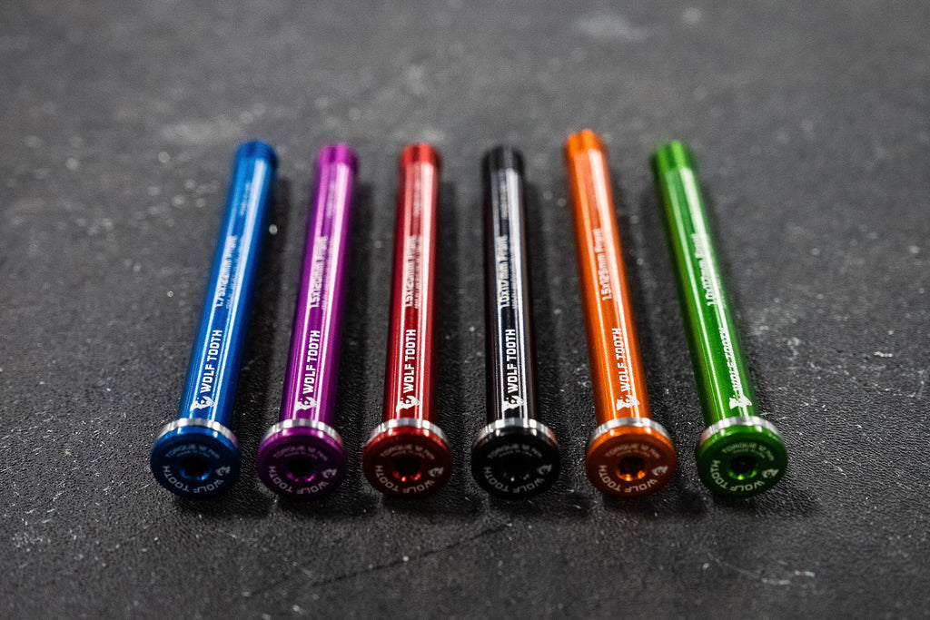 Wolf Tooth bike axles in six colors and several sizes