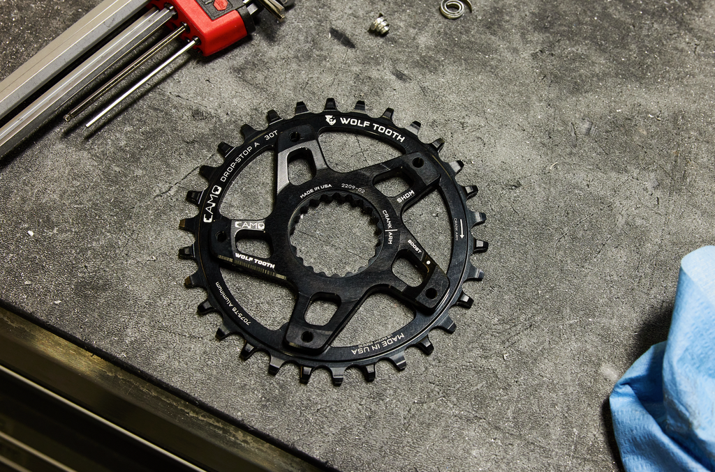 Wolf Tooth's CAMO Direct Mount for Shimano spider nestled on top of a CAMO Round Aluminum Chainring.