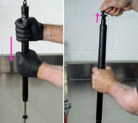 image showing piston rod being pushed down on bench to unseat the cartridge