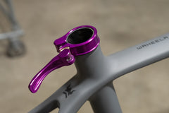 Installed purple Wolf Tooth QR Seatpost Clamp on bike