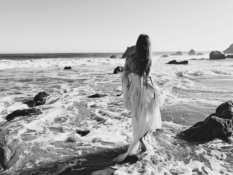 Bridal Fashion Designer Lauren Elaine wades into the ocean in a bohemian wedding gown in Malibu