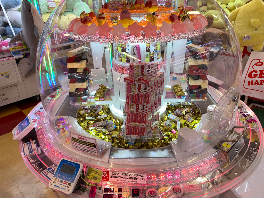 Japanese crane game with candy and snack rewards in Japanese game arcade