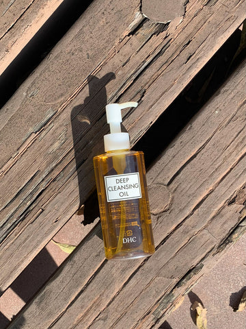 japanese facial oil cleanser DHC Deep cleansing oil lying on the ground stylish lifestyle photo DHC 薬用ディープクレンジングオイル