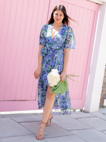 GIRL WEARING THE NORA FLUTTER SLEEVE MAXI WRAP DRESS (BLUE)