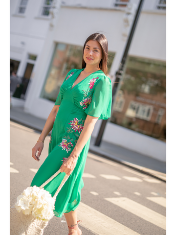 GIRL WEARING THE HANNAH EMBROIDERED FLUTTER SLEEVE MIDI DRESS (GREEN)