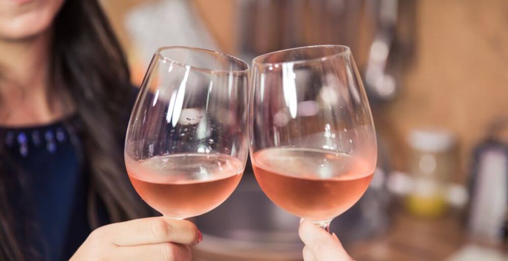 Rosé Wine Glasses Clinking Together