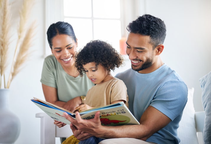 boy-reading-a-book-about-dinosaurs