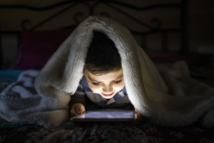 child-with-issues-to-sleep-using-tablet-in-his-bed