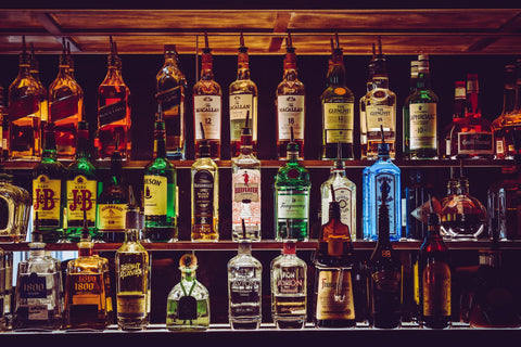 Bar with bottles of alcohol on the shelf. 