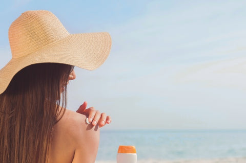 Woman Applying CBD Sunscreen