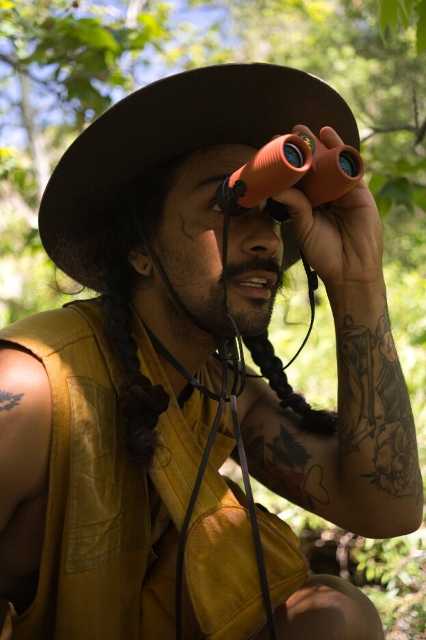 Picture of Jesse “SunWolf” Temple looking through his Nocs binoculars