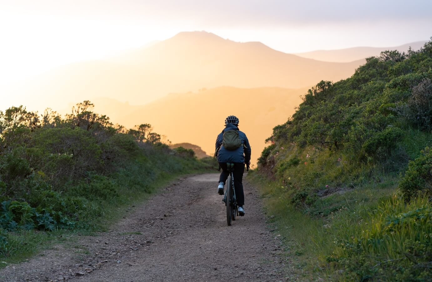 Mary Tolosa riding a mountain bike on a trail