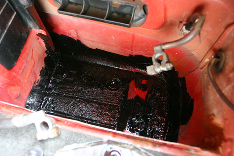 Battery compartment with black POR-15 painted on it.