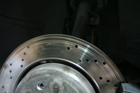 Clogged cross-drilled holes in brake rotor.