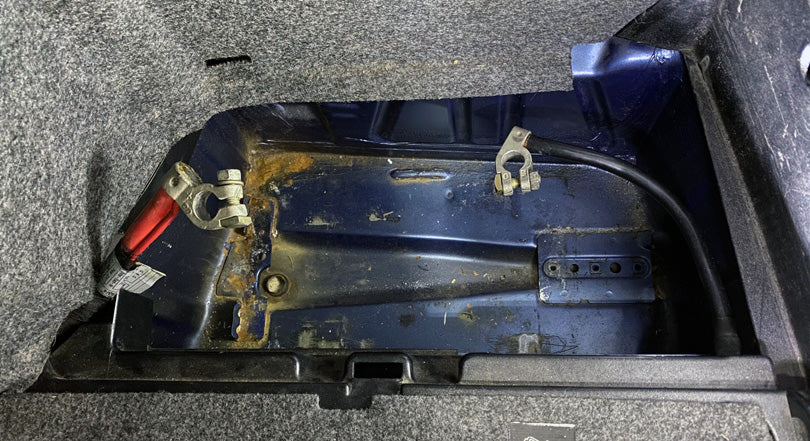 BMW E36 M3 battery compartment with rust.
