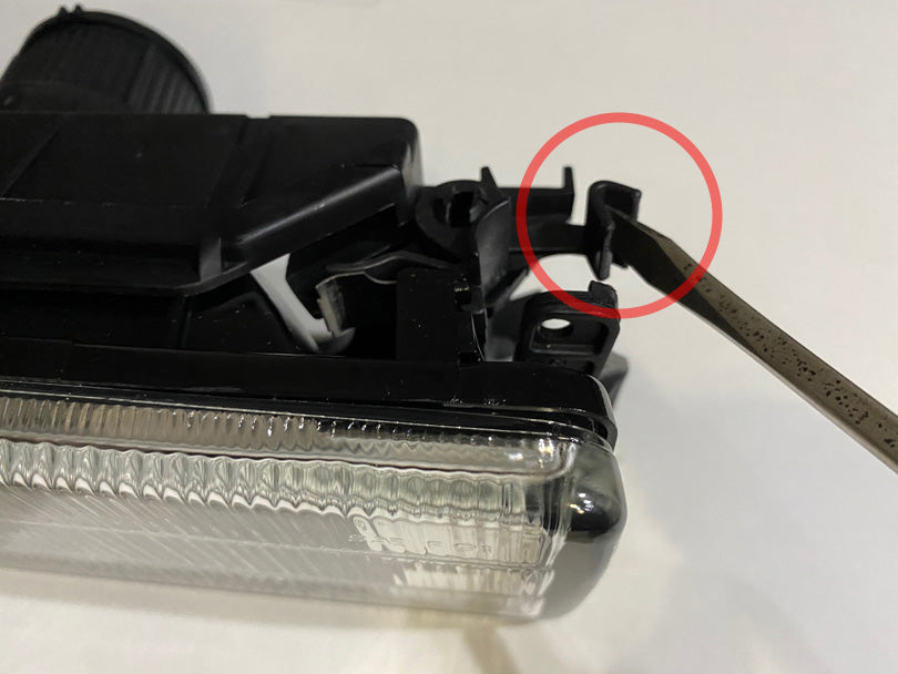 Foglight removed, with the release tab circled in red.