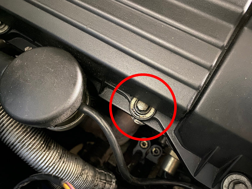 BMW E36 M3 S52 with oil leak from valve cover. Leaking area is circled.