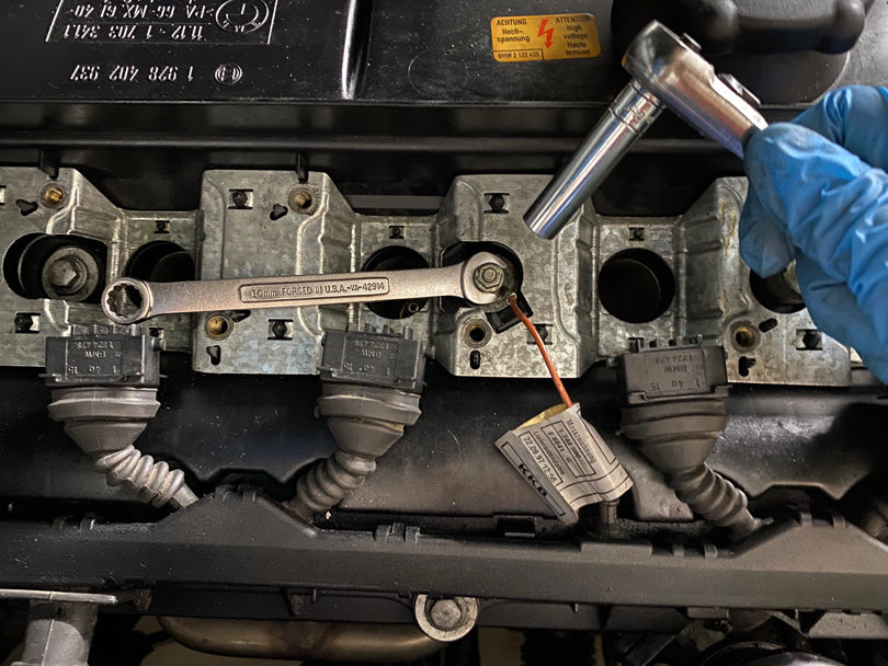 Wrench and socket loosening nut that holds the ground wire to the valve cover.