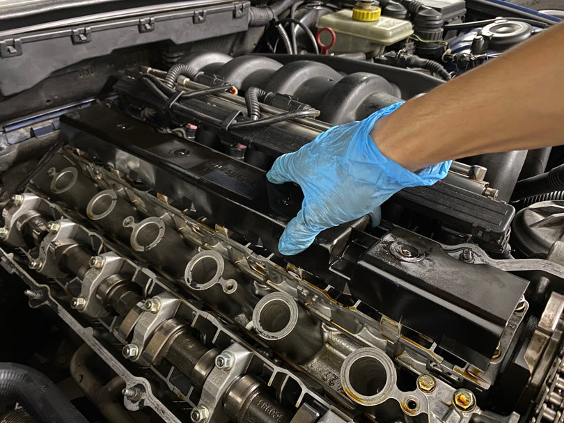 Cam tray cover being removed from BMW E36 M3.