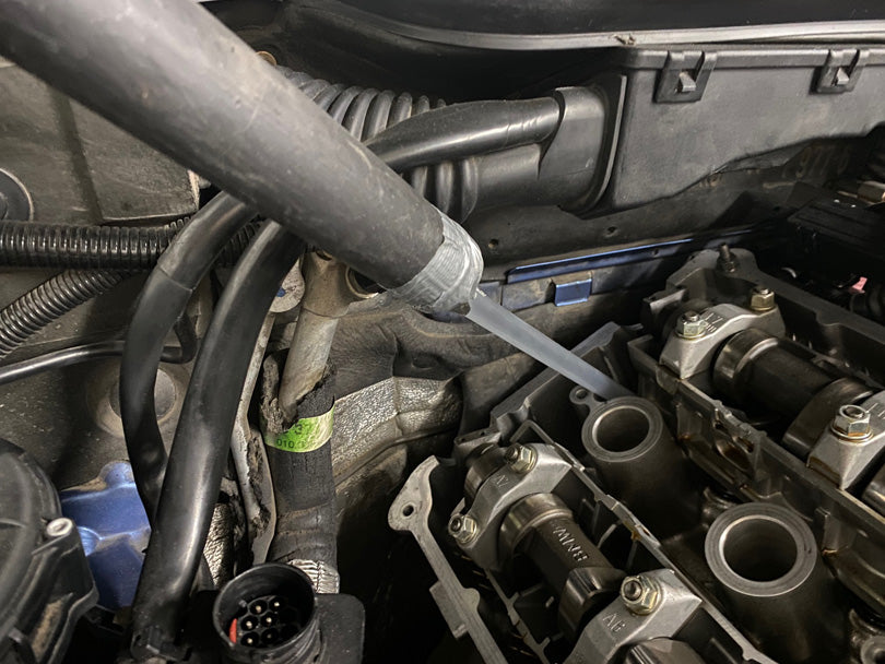 Shop Vac with homemade nozzle made from a boba straw for getting down into the hard-to-reach crevices of the head and vacuuming up the bits of old RTV.