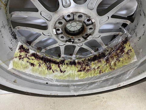 Wheel with stubborn brake dust inside the barrel being treated with Sonax wheel cleaner.