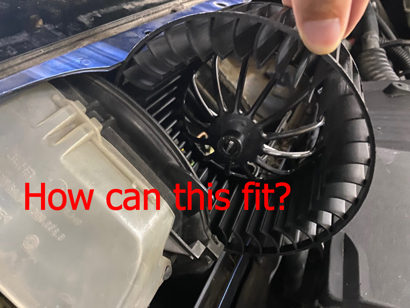 BMW E36 HVAC blower fan cage shown next to the access opening it is supposed to fit through. The text reads "How can this fit?".