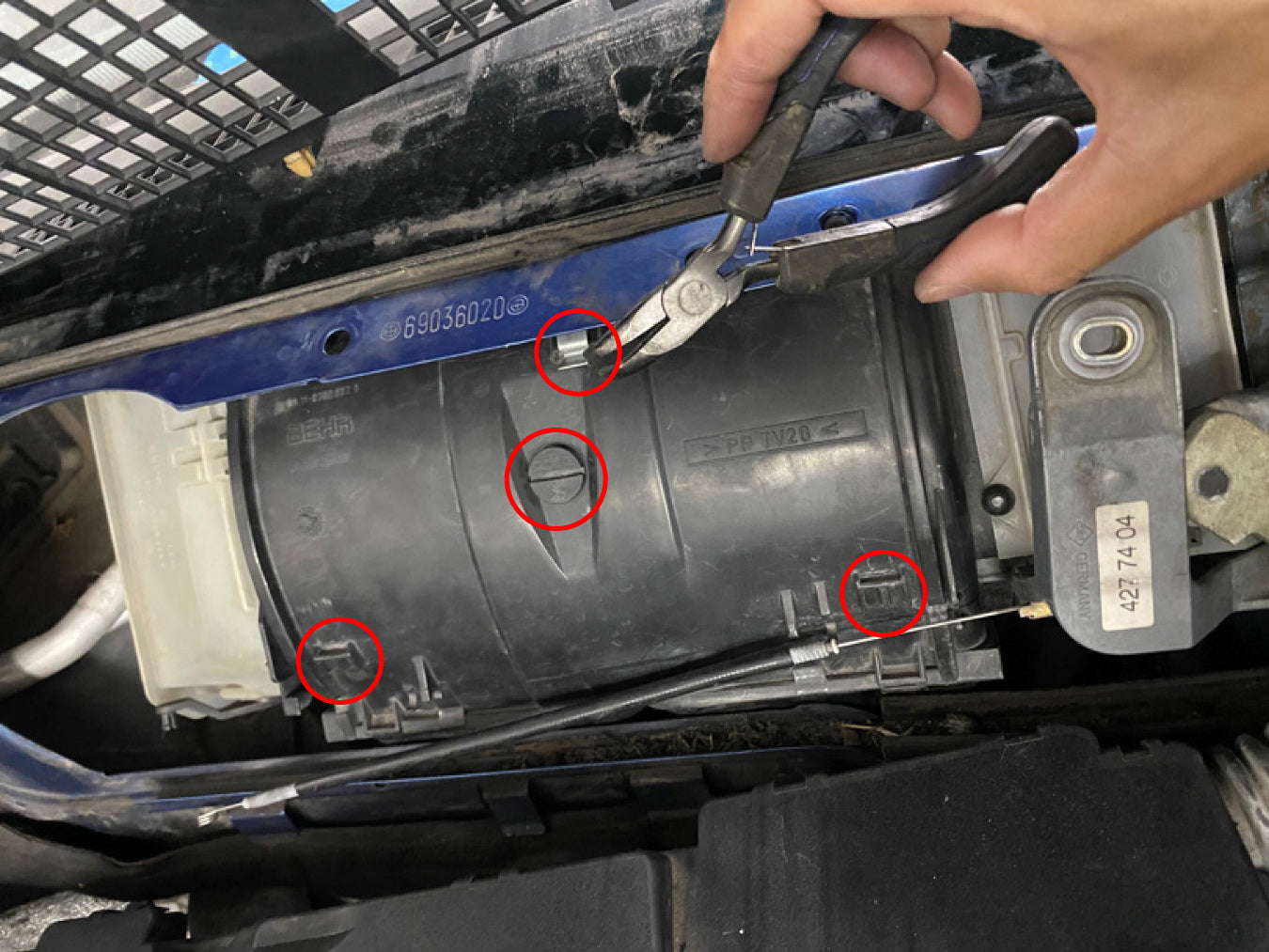BMW E36 HVAC fan cover fastener locations circled.